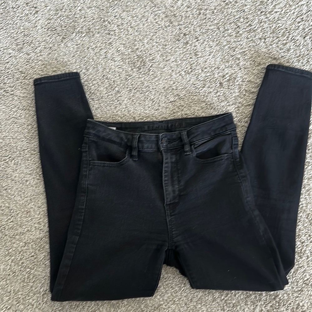 AE black busted knee skinny jeans